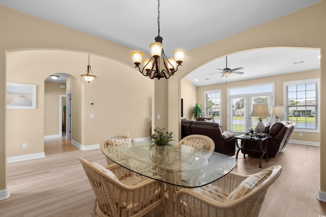 1149 6th Ave S, North Myrtle Beach, SC 29582 - dining room featuring arched walkways, light wood-style flooring, a ceiling fan, and baseboards