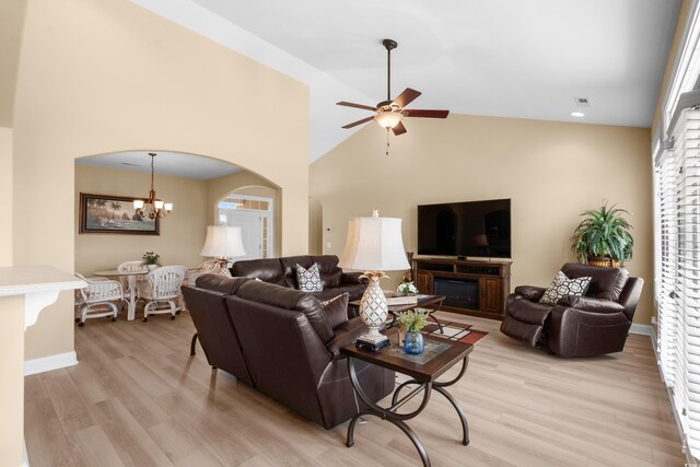 1149 6th Ave S, North Myrtle Beach, SC 29582 - living room featuring light wood-style flooring, ceiling fan, baseboards, arched walkways, and a chandelier