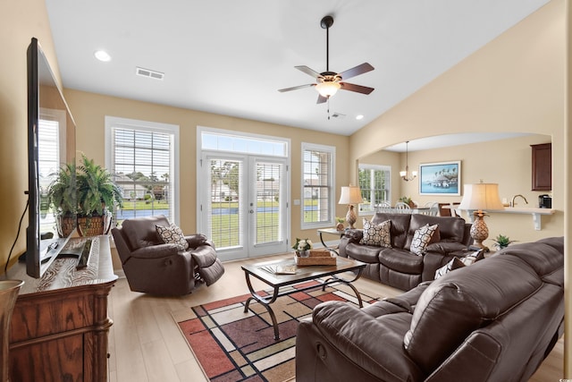 1149 6th Ave S, North Myrtle Beach, SC 29582 - living area with healthy amount of natural light, arched walkways, ceiling fan, vaulted ceiling, and light wood finished floors
