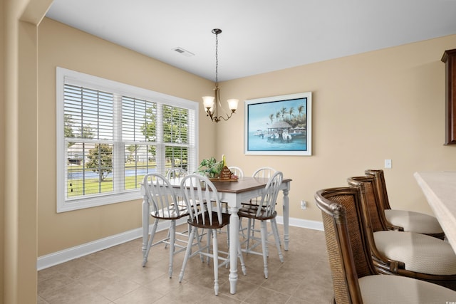 1149 6th Ave S, North Myrtle Beach, SC 29582 - dining space with baseboards, a chandelier, and light tile patterned floors