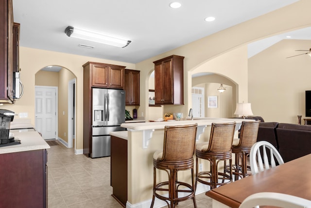 1149 6th Ave S, North Myrtle Beach, SC 29582 - kitchen with stainless steel appliances, arched walkways, a breakfast bar, light countertops, and recessed lighting