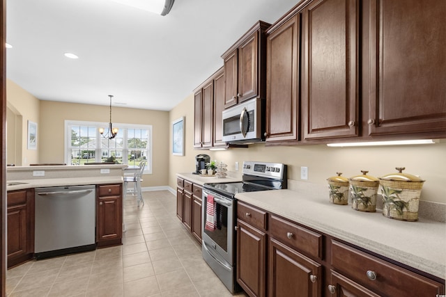 1149 6th Ave S, North Myrtle Beach, SC 29582 - kitchen with appliances with stainless steel finishes, light countertops, light tile patterned floors, a chandelier, and pendant lighting
