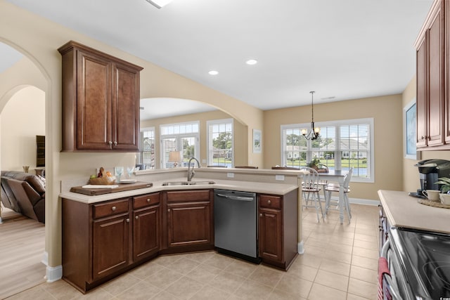 1149 6th Ave S, North Myrtle Beach, SC 29582 - kitchen featuring stainless steel appliances, a sink, arched walkways, light countertops, and a peninsula