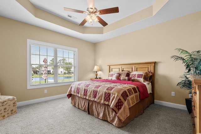 1149 6th Ave S, North Myrtle Beach, SC 29582 - bedroom featuring carpet floors, baseboards, a tray ceiling, and ceiling fan