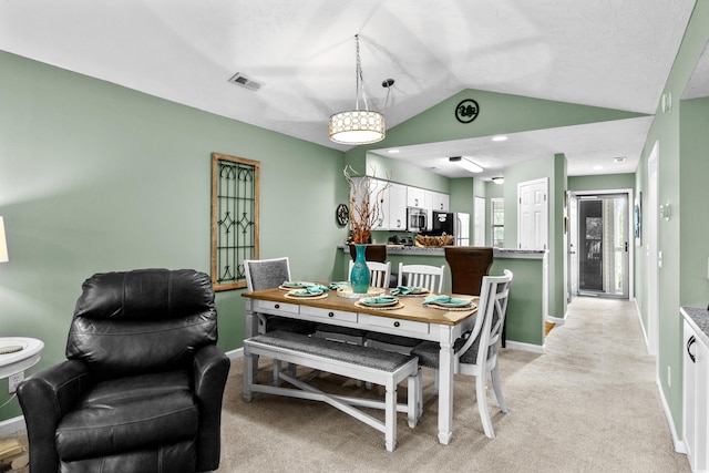 117 Pinehurst Ln Unit 5-J, Pawleys Island, SC 29585 - dining room featuring lofted ceiling, baseboards, and light carpet