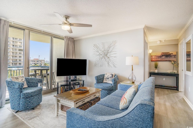 8560 Queensway Blvd Unit 106, Myrtle Beach, SC 29572 - living area featuring wood finished floors, ornamental molding, a textured ceiling, ceiling fan, and expansive windows