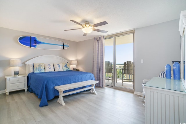 8560 Queensway Blvd Unit 106, Myrtle Beach, SC 29572 - bedroom with access to outside, expansive windows, light wood-style flooring, baseboards, and a ceiling fan
