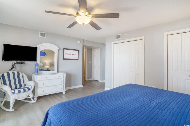 8560 Queensway Blvd Unit 106, Myrtle Beach, SC 29572 - bedroom with light wood finished floors, two closets, baseboards, and a ceiling fan