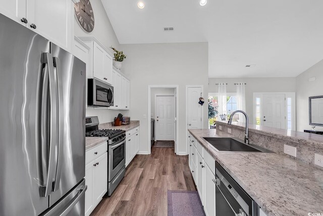 832 Windsor Rose Dr, Conway, SC 29526 - kitchen with appliances with stainless steel finishes, a sink, wood finished floors, light stone counters, and white cabinetry
