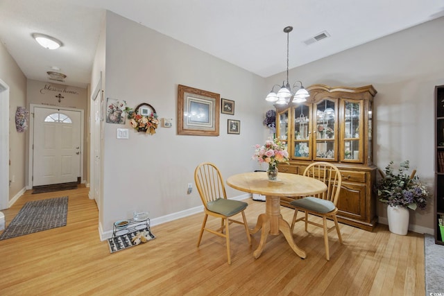 155 Lazy Willow Ln Unit 103, Myrtle Beach, SC 29572 - dining space with light wood finished floors, a chandelier, and baseboards