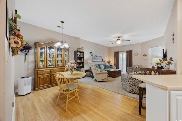 155 Lazy Willow Ln Unit 103, Myrtle Beach, SC 29572 - dining room featuring a ceiling fan, light wood-type flooring, and a chandelier