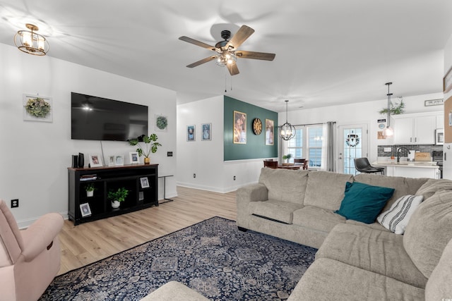 136 Southbury Dr, Myrtle Beach, SC 29588 - living room featuring light wood finished floors, ceiling fan, and a chandelier