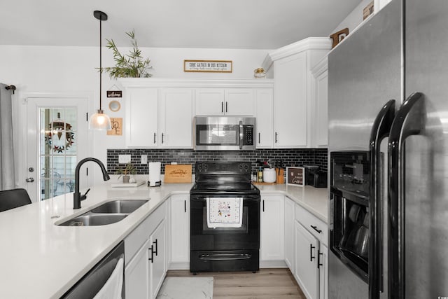 136 Southbury Dr, Myrtle Beach, SC 29588 - kitchen with stainless steel appliances, light countertops, white cabinets, backsplash, and pendant lighting