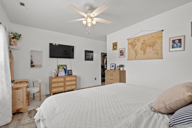 136 Southbury Dr, Myrtle Beach, SC 29588 - bedroom with wood finished floors, a spacious closet, ceiling fan, and a closet