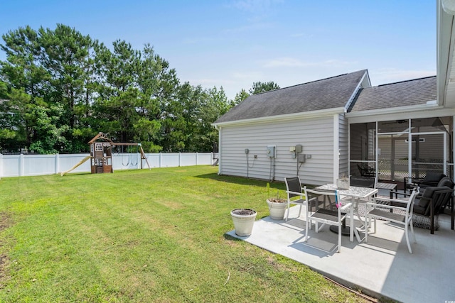 136 Southbury Dr, Myrtle Beach, SC 29588 - fenced backyard featuring a patio, a playground, and a sunroom