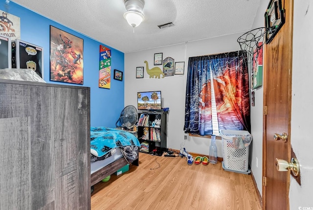 405 Flagstone Dr, Myrtle Beach, SC 29588 - bedroom featuring a textured ceiling and wood finished floors
