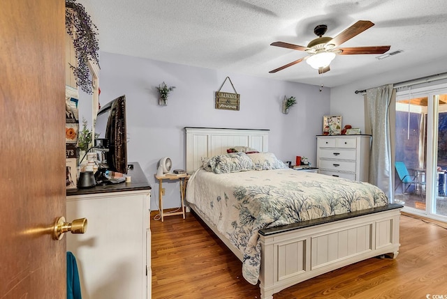 405 Flagstone Dr, Myrtle Beach, SC 29588 - bedroom with light wood-style flooring, access to outside, multiple windows, a textured ceiling, and a ceiling fan