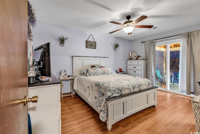405 Flagstone Dr, Myrtle Beach, SC 29588 - bedroom featuring light wood-style floors, multiple windows, access to outside, a textured ceiling, and ceiling fan