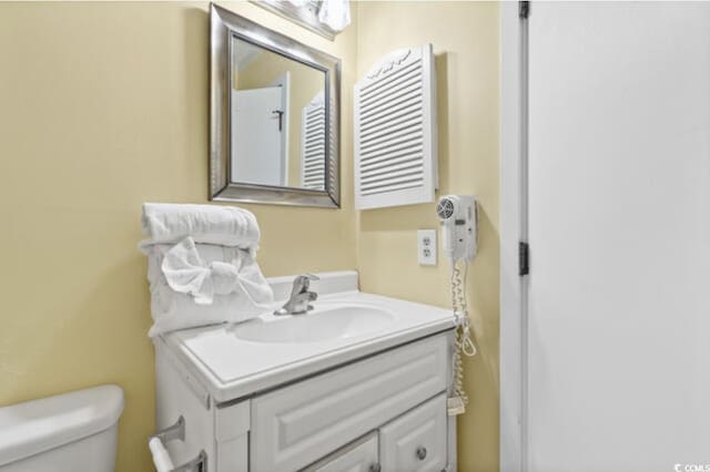 5905 S Kings Hwy Unit 206A, Myrtle Beach, SC 29575 - half bathroom with radiator heating unit, toilet, and vanity