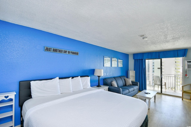 1207 S Ocean Blvd Unit 51012, Myrtle Beach, SC 29577 - bedroom featuring a textured ceiling, a textured wall, access to exterior, and wood finished floors