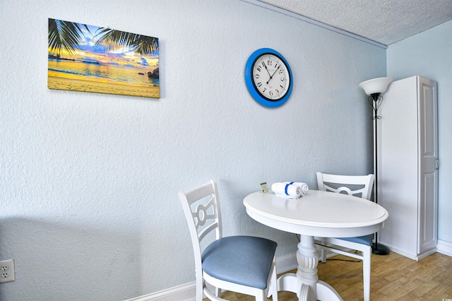 1207 S Ocean Blvd Unit 51012, Myrtle Beach, SC 29577 - dining area featuring wood finished floors, a textured ceiling, and baseboards