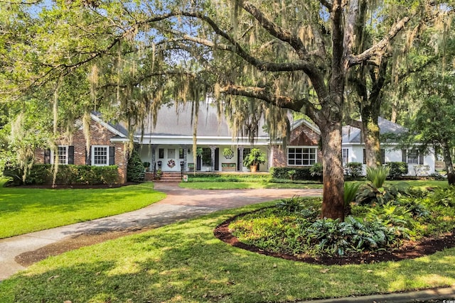 1259 Oatland Lake Rd, Pawleys Island, SC 29585 - view of front facade featuring a front yard and brick siding
