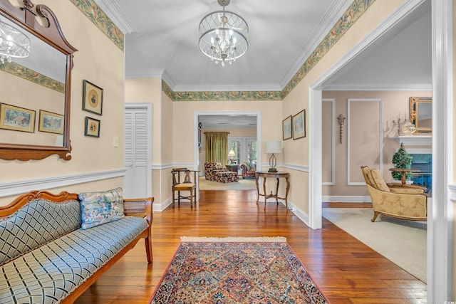 1259 Oatland Lake Rd, Pawleys Island, SC 29585 - entrance foyer featuring a chandelier, hardwood / wood-style floors, and ornamental molding