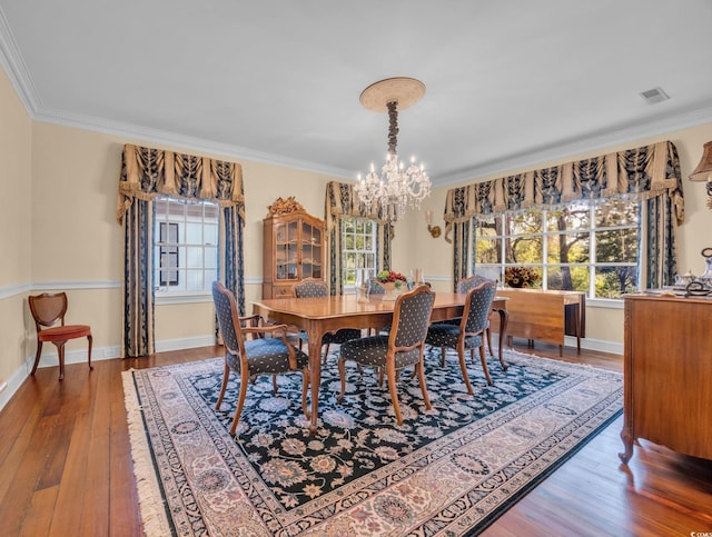 1259 Oatland Lake Rd, Pawleys Island, SC 29585 - dining space featuring a chandelier, wood-type flooring, healthy amount of natural light, ornamental molding, and baseboards