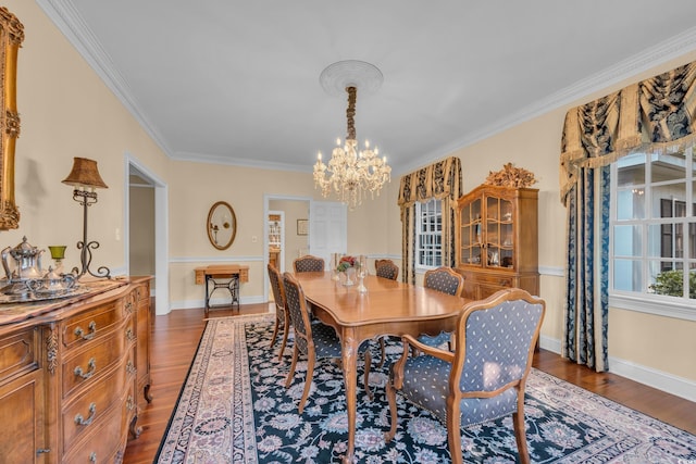 1259 Oatland Lake Rd, Pawleys Island, SC 29585 - dining space with a chandelier, ornamental molding, dark wood-style flooring, and baseboards