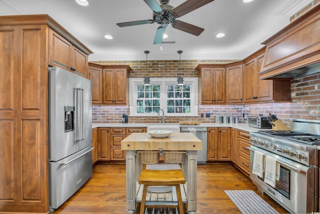 1259 Oatland Lake Rd, Pawleys Island, SC 29585 - kitchen with high quality appliances, a sink, ceiling fan, custom range hood, and crown molding