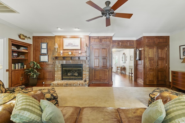 1259 Oatland Lake Rd, Pawleys Island, SC 29585 - carpeted living area featuring crown molding, ceiling fan, a fireplace, and wood finished floors