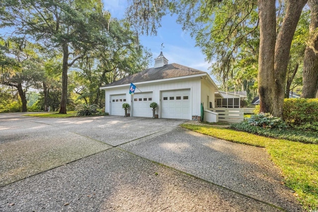1259 Oatland Lake Rd, Pawleys Island, SC 29585 - view of property exterior with a garage, concrete driveway, and roof with shingles