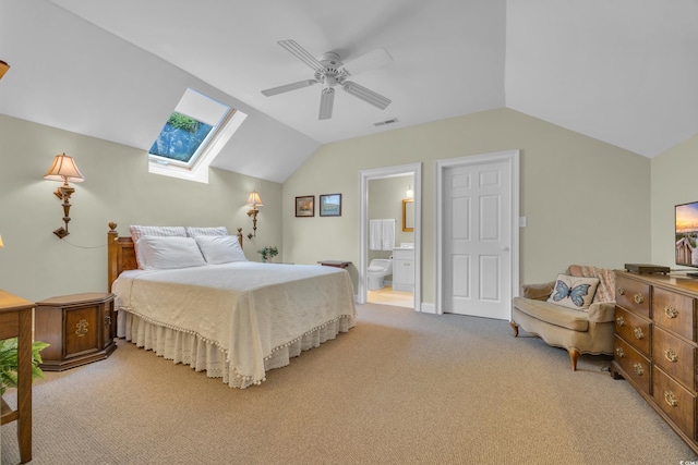1259 Oatland Lake Rd, Pawleys Island, SC 29585 - bedroom featuring vaulted ceiling, light carpet, a skylight, connected bathroom, and a ceiling fan