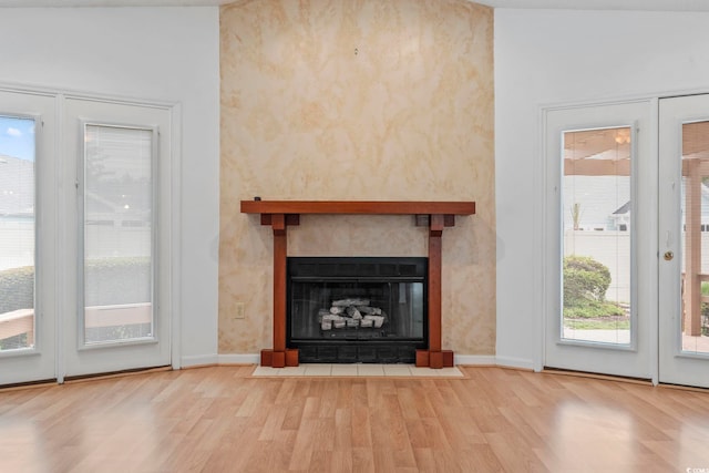 1468 Fox Hollow Way N, Myrtle Beach, SC 29582 - unfurnished living room featuring wood finished floors, baseboards, and a fireplace with flush hearth