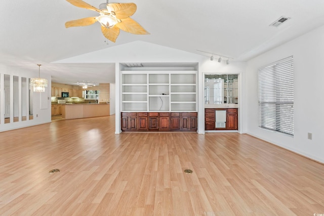 1468 Fox Hollow Way N, Myrtle Beach, SC 29582 - unfurnished living room with a chandelier, track lighting, vaulted ceiling, ceiling fan, and light wood-type flooring
