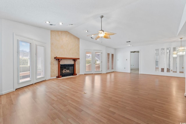 1468 Fox Hollow Way N, Myrtle Beach, SC 29582 - unfurnished living room featuring healthy amount of natural light, lofted ceiling, ceiling fan, light wood-type flooring, and a chandelier