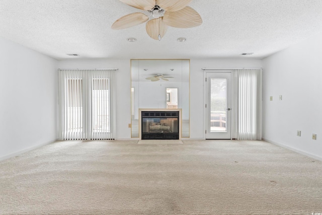 1468 Fox Hollow Way N, Myrtle Beach, SC 29582 - unfurnished living room featuring ceiling fan, a textured ceiling, a fireplace with flush hearth, and carpet floors