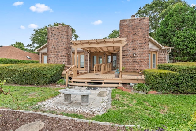 1468 Fox Hollow Way N, Myrtle Beach, SC 29582 - back of property with a chimney, a deck, brick siding, a pergola, and a yard