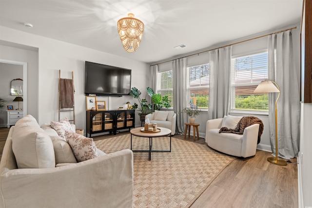 1523 Wood Stork Dr, Conway, SC 29526 - living room featuring wood finished floors, a chandelier, and baseboards
