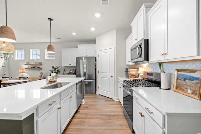 1523 Wood Stork Dr, Conway, SC 29526 - kitchen featuring appliances with stainless steel finishes, a sink, light wood-type flooring, recessed lighting, and light countertops