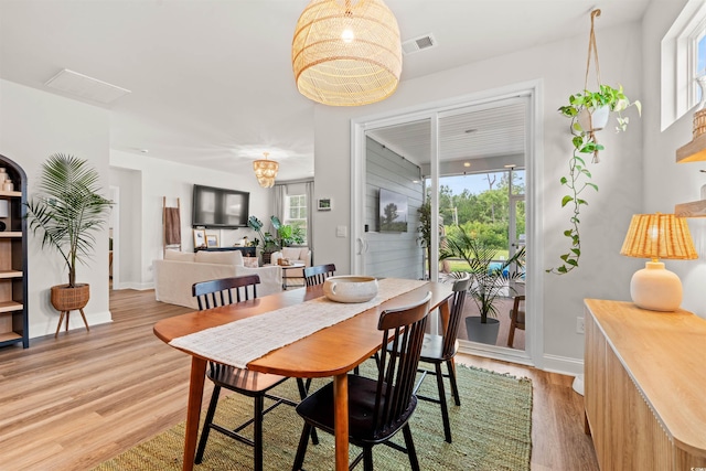 1523 Wood Stork Dr, Conway, SC 29526 - dining space with light wood-style flooring, a chandelier, and baseboards