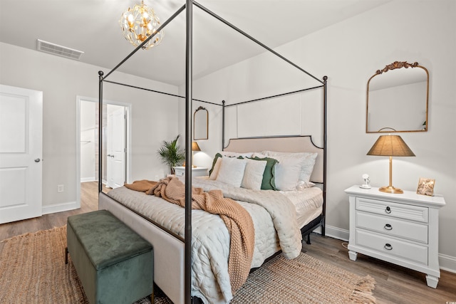 1523 Wood Stork Dr, Conway, SC 29526 - bedroom featuring wood finished floors, baseboards, and a chandelier