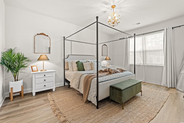 1523 Wood Stork Dr, Conway, SC 29526 - bedroom with light wood finished floors, a chandelier, and baseboards