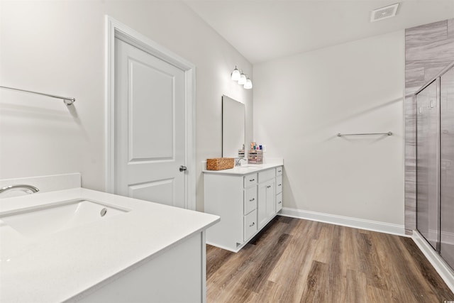 1523 Wood Stork Dr, Conway, SC 29526 - full bathroom featuring two vanities, a shower stall, wood finished floors, and baseboards