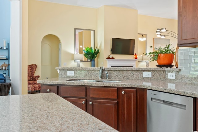 106 Cypress Creek Dr, Murrells Inlet, SC 29576 - kitchen with stainless steel dishwasher, a sink, arched walkways, and light stone countertops