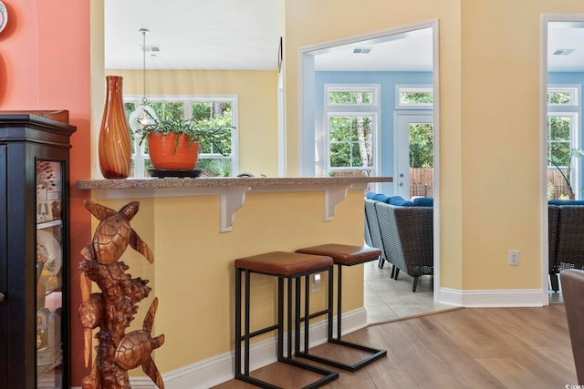 106 Cypress Creek Dr, Murrells Inlet, SC 29576 - kitchen with light wood-style flooring, a kitchen bar, and baseboards