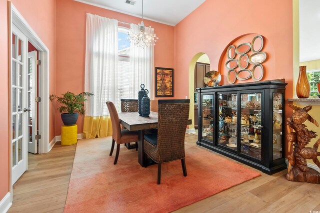 106 Cypress Creek Dr, Murrells Inlet, SC 29576 - dining space with wood finished floors, a chandelier, plenty of natural light, and arched walkways