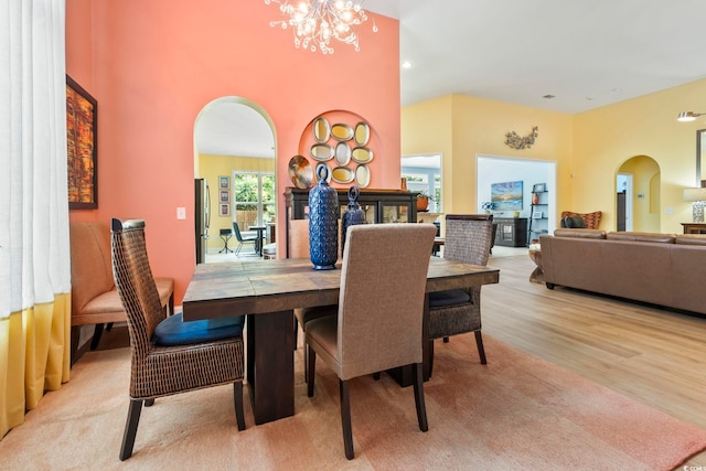 106 Cypress Creek Dr, Murrells Inlet, SC 29576 - dining space featuring arched walkways, a chandelier, and wood finished floors