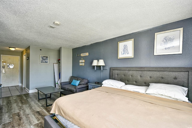 1207 S Ocean Blvd Unit 50809, Myrtle Beach, SC 29577 - bedroom featuring wood finished floors and a textured ceiling