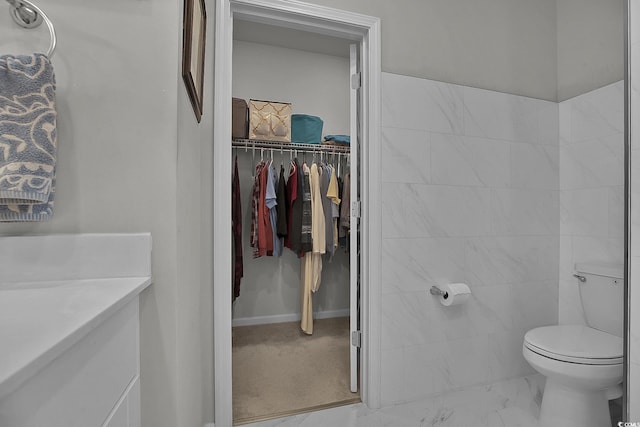 79 S Reindeer Rd, Surfside Beach, SC 29575 - bathroom with marble finish flooring, toilet, a walk in closet, and vanity